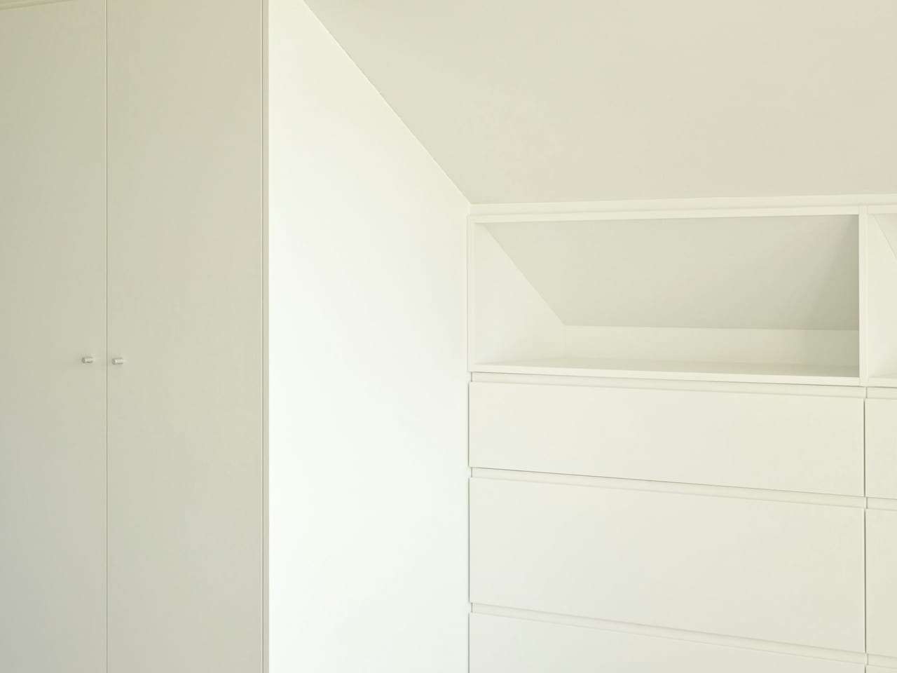 Bespoke fitted slatted wood feature wall in a London living room with concealed shelving and integrated lighting
