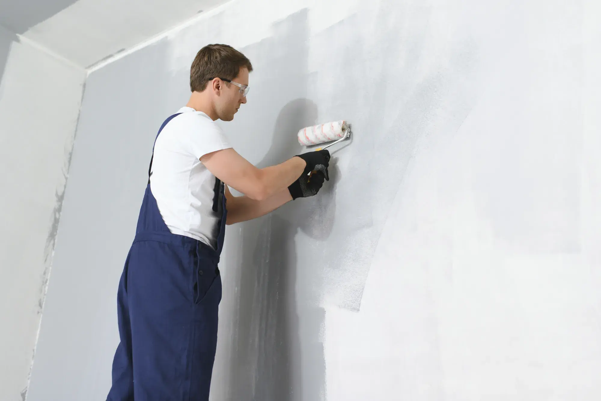 Jet Painting team member rolling fresh paint on a residential interior wall